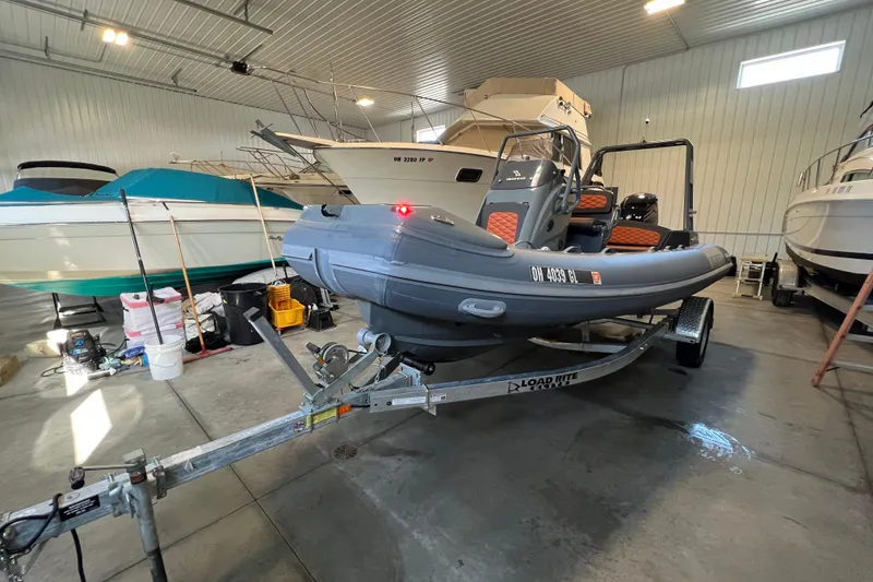 Slide: The Image of 2024 Highfield Sport 560 boat on trailer in indoor storage facility. - 4