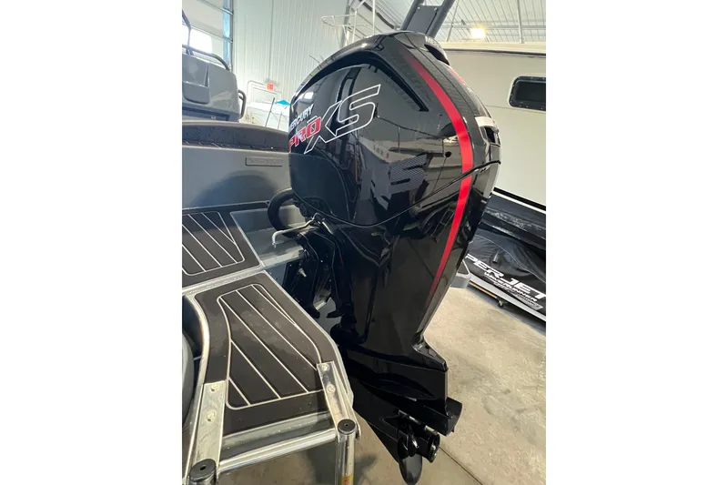 Slide: The Image of 2024 Highfield Sport 560 with Mercury Pro XS outboard motor in a showroom. - 6