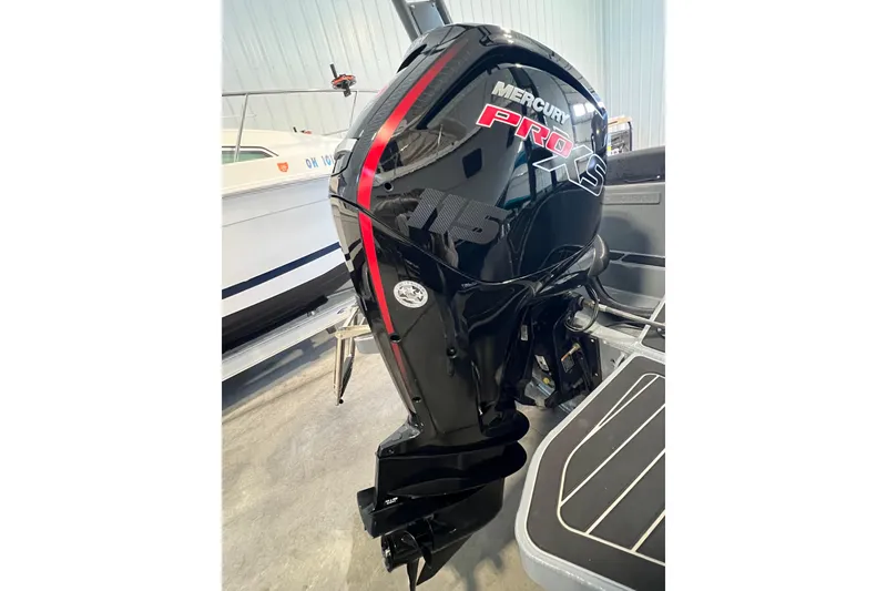 Slide: The Image of 2024 Highfield Sport 560 with Mercury Pro outboard motor in a showroom. - 7