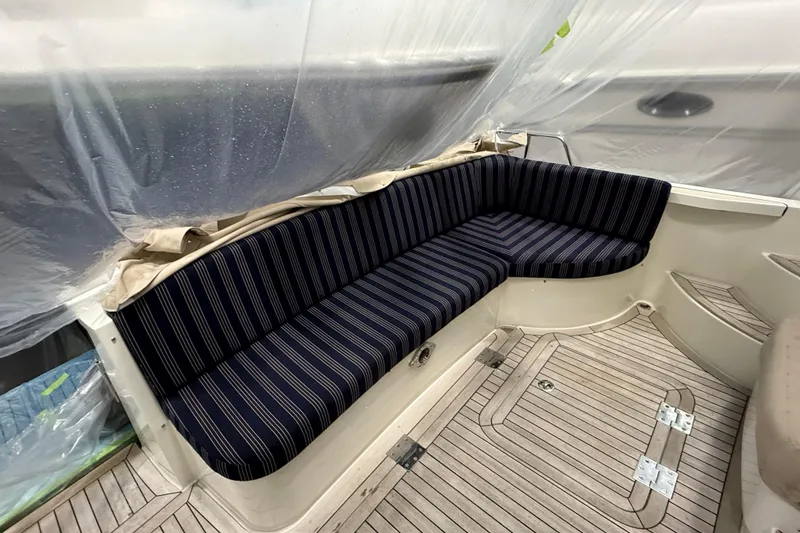 Slide: The Image of 2021 Sabre 42 Fly Bridge interior with striped seating and wooden flooring. - 10