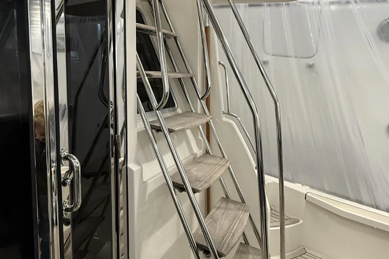 Slide: The Image of Staircase on 2021 Sabre 42 Fly Bridge yacht with sleek metal railings. - 12