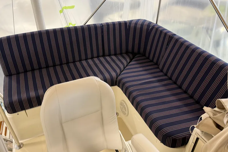 Slide: The Image of 2021 Sabre 42 Fly Bridge interior with striped seating and white chair. - 14