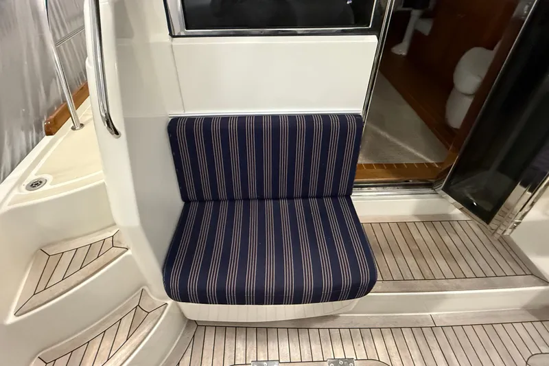 Slide: The Image of 2021 Sabre 42 Fly Bridge interior with striped seating and wooden flooring. - 15