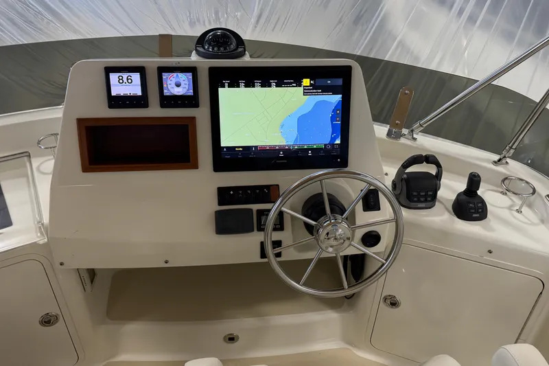 Slide: The Image of Helm of 2021 Sabre 42 Fly Bridge with navigation screens and controls. - 18
