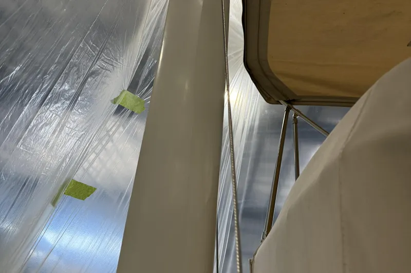 Slide: The Image of 2021 Sabre 42 Fly Bridge yacht detail with protective covering and support structure. - 25