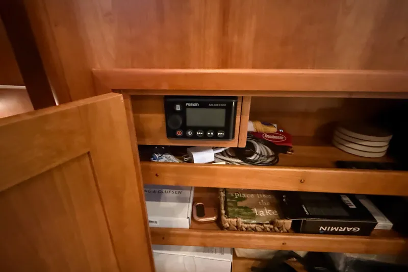 Slide: The Image of Wooden cabinet interior with Fusion MS-NRX200 stereo on a 2021 Sabre 42 Fly Bridge. - 28