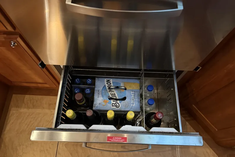 Slide: The Image of Refrigerator drawer with beverages on 2021 Sabre 42 Fly Bridge yacht. - 30