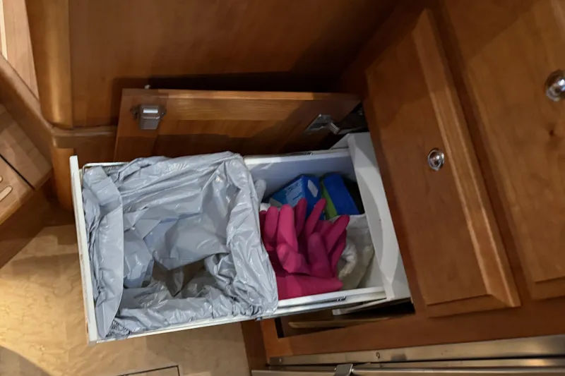 Slide: The Image of Pull-out trash bin and cleaning supplies in Sabre 42 Fly Bridge, 2021 model. - 31