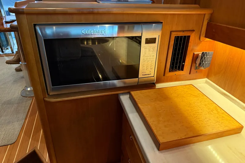Slide: The Image of 2021 Sabre 42 Fly Bridge kitchen with Cuisinart microwave and wooden countertop. - 32