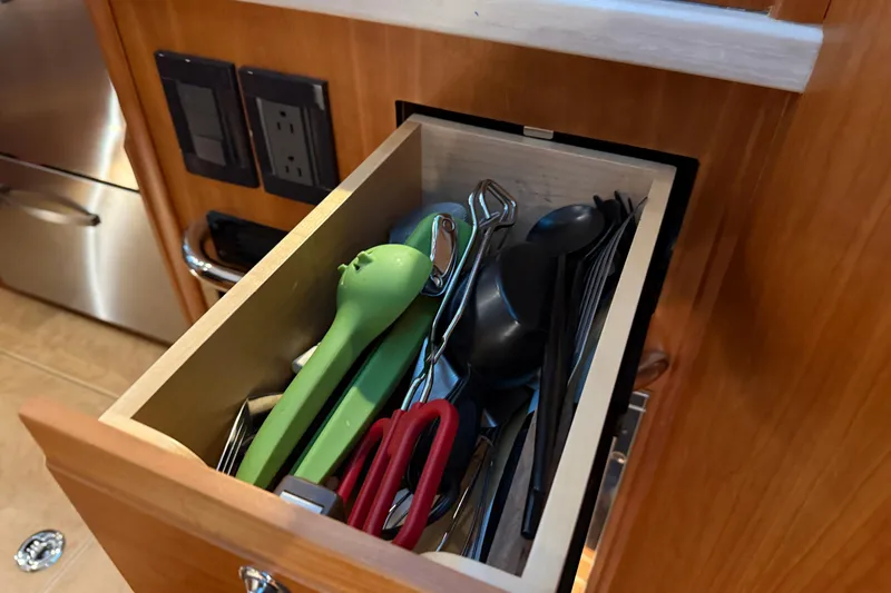 Slide: The Image of Drawer with kitchen utensils in 2021 Sabre 42 Fly Bridge yacht. - 43