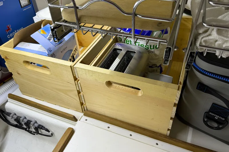 Slide: The Image of Wooden storage boxes with a toaster and supplies on a Sabre 42 Fly Bridge yacht. - 45