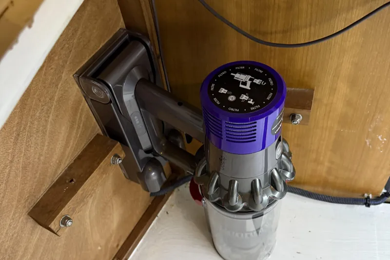 Slide: The Image of Cordless vacuum mounted on a wooden wall inside a 2021 Sabre 42 Fly Bridge. - 47