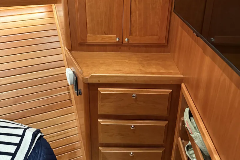 Slide: The Image of 2021 Sabre 42 Fly Bridge interior with wooden cabinetry and drawers, showcasing elegant design. - 52
