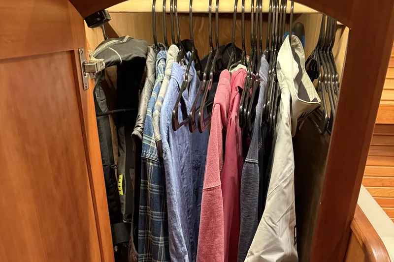 Slide: The Image of Clothes hanging in a wooden closet on a 2021 Sabre 42 Fly Bridge yacht. - 55