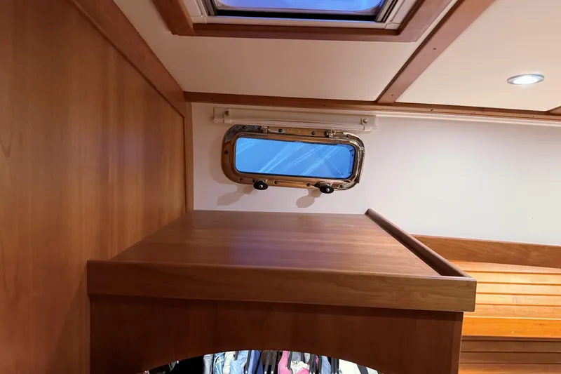Slide: The Image of Interior of 2021 Sabre 42 Fly Bridge with wooden cabinetry and porthole window. - 56