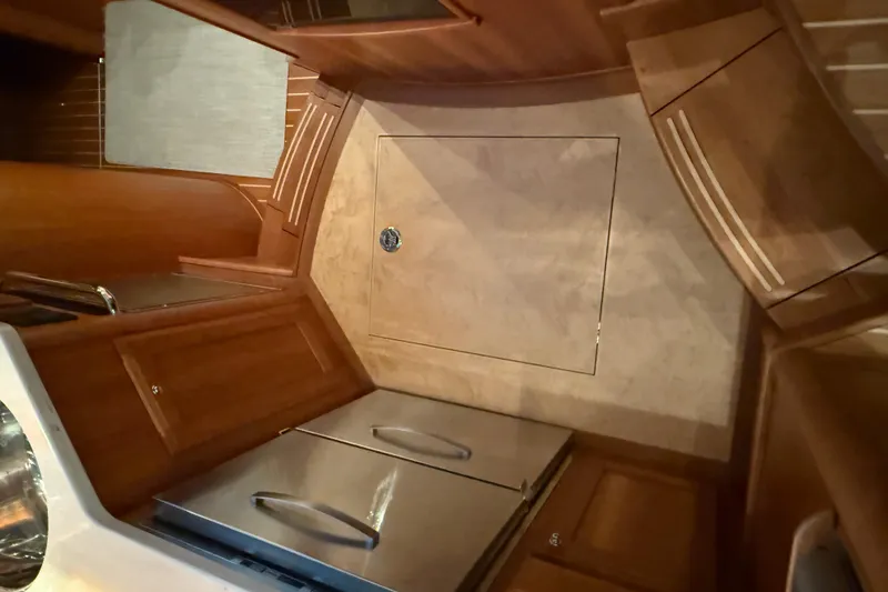 Slide: The Image of Interior of 2021 Sabre 42 Fly Bridge yacht with wooden cabinetry and stainless steel appliances. - 59