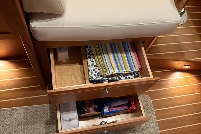 Slide: The Image of Wooden drawers with colorful linens inside a 2021 Sabre 42 Fly Bridge yacht interior. - 62