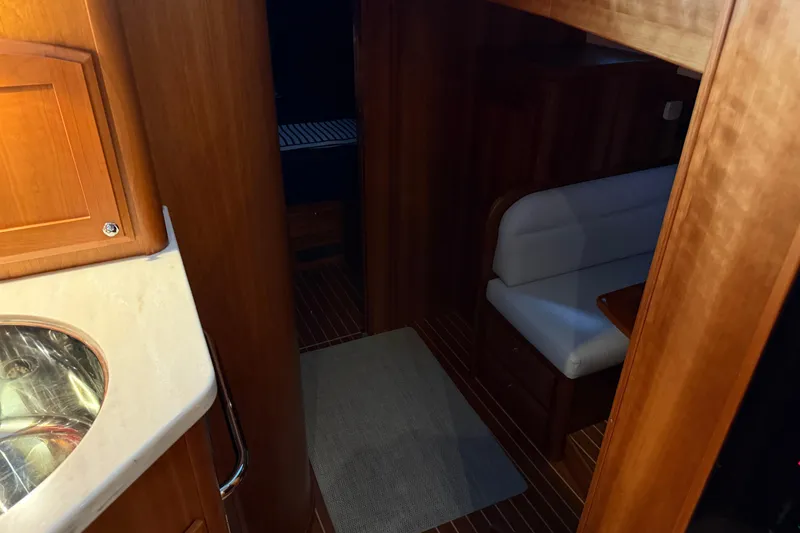 Slide: The Image of 2021 Sabre 42 Fly Bridge interior with wood finish and seating area. - 70