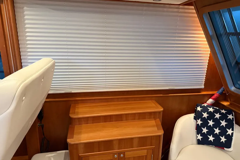 Slide: The Image of Interior of 2021 Sabre 42 Fly Bridge with wooden cabinetry and star-patterned decor. - 73