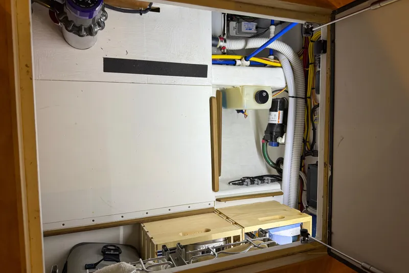 Slide: The Image of Engine room of 2021 Sabre 42 Fly Bridge with visible wiring and components. - 74