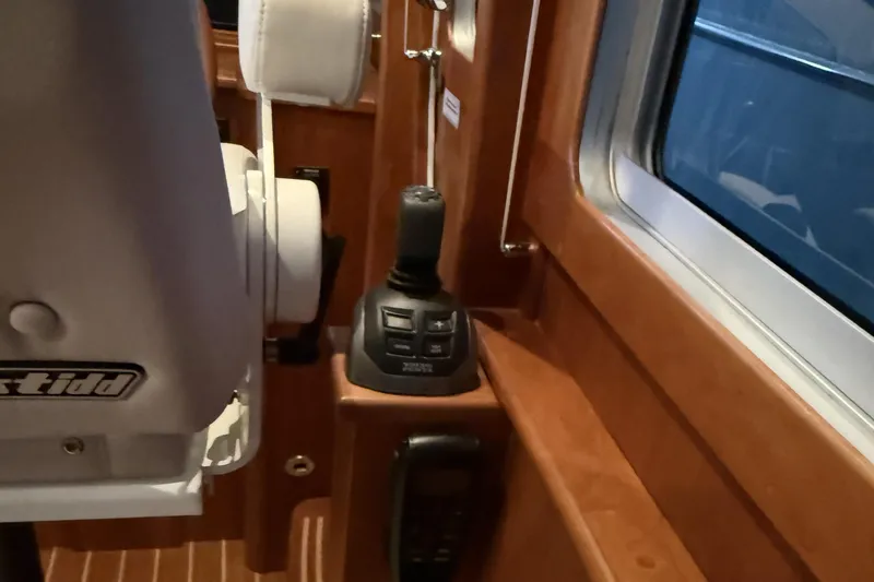 Slide: The Image of Interior of 2021 Sabre 42 Fly Bridge yacht with joystick control and seating. - 75