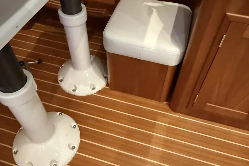 Slide: The Image of Interior of 2021 Sabre 42 Fly Bridge with wooden flooring and cushioned seating. - 76