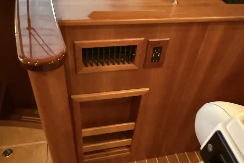 Slide: The Image of Interior of 2021 Sabre 42 Fly Bridge yacht with wooden paneling and electrical outlet. - 77