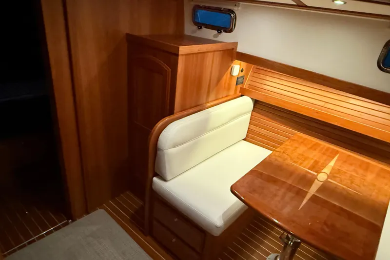 Slide: The Image of Luxurious interior of 2021 Sabre 42 Fly Bridge with wooden table and cushioned seating. - 78