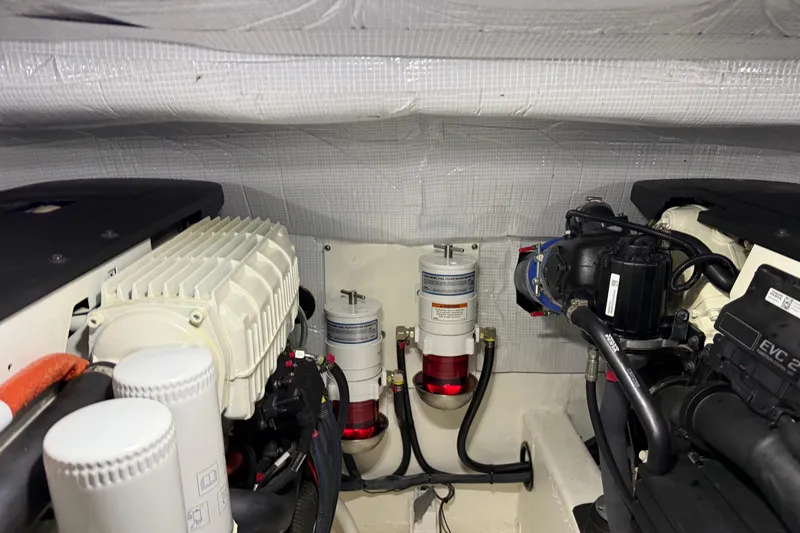 Slide: The Image of Engine room of 2021 Sabre 42 Fly Bridge with visible components and wiring. - 83