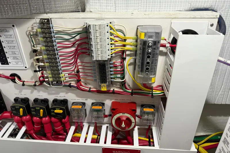 Slide: The Image of Electrical panel of 2021 Sabre 42 Fly Bridge with organized wiring and switches. - 84