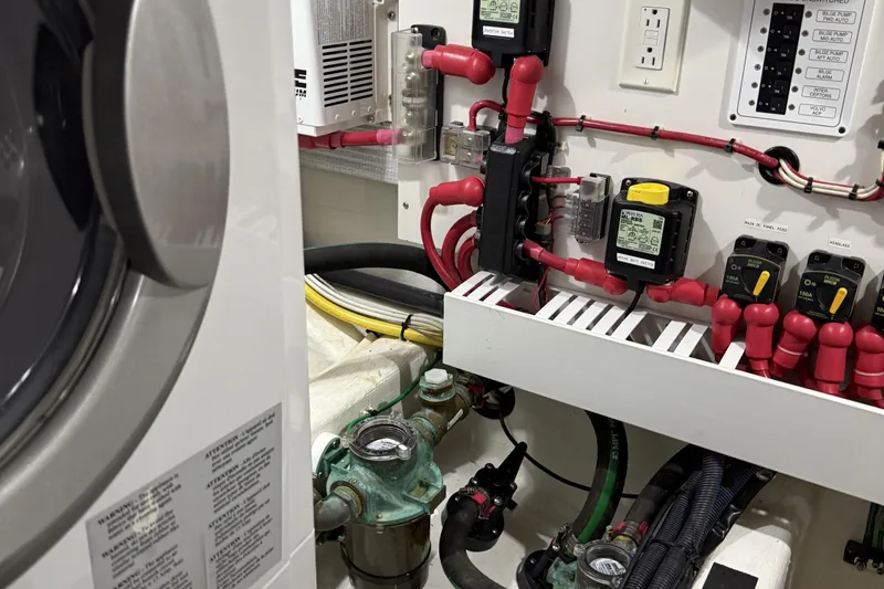 Slide: The Image of Engine room of 2021 Sabre 42 Fly Bridge with electrical components and wiring. - 85