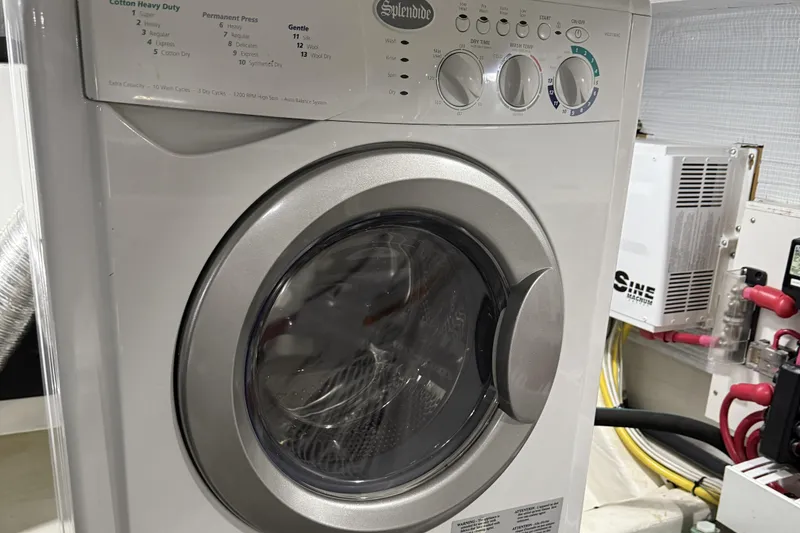 Slide: The Image of Front-loading washing machine in a 2021 Sabre 42 Fly Bridge yacht laundry area. - 86
