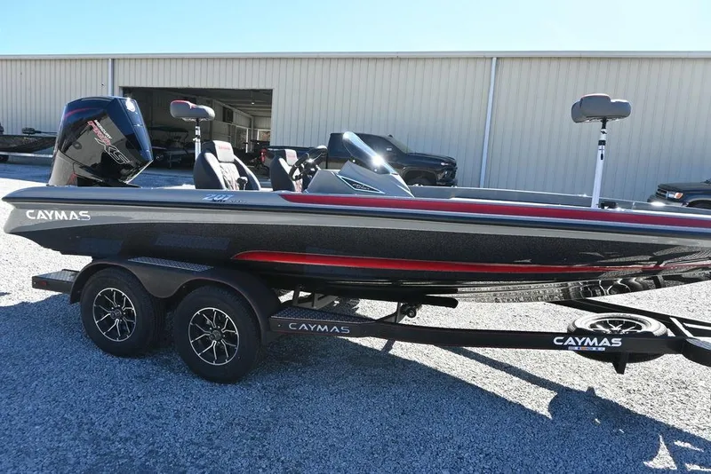 Slide: The Image of 2025 Caymas 201 Pro boat on trailer, sleek design, parked outdoors. - 2
