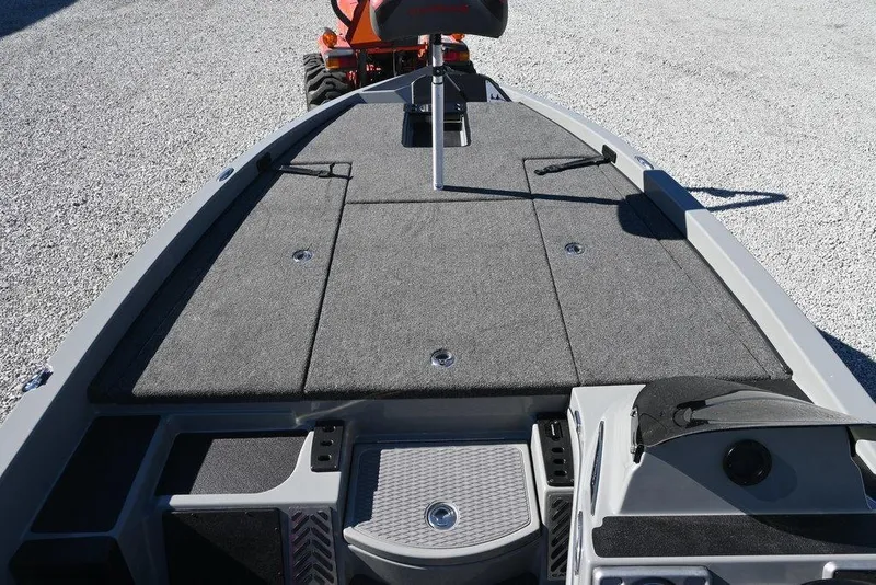 Slide: The Image of 2025 Caymas 201 Pro boat deck with gray carpeting and storage compartments. - 7