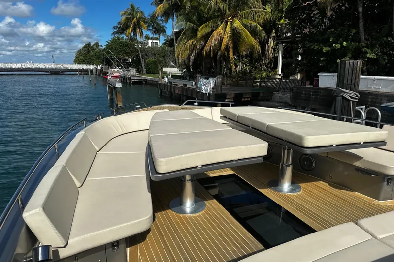 Slide: The Image of Luxurious CNM 54 yacht deck with seating, docked near palm trees, 2019 model. - 19