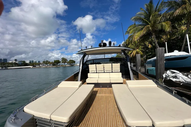 Slide: The Image of Luxurious 2019 CNM 54 yacht docked by palm trees under a clear blue sky. - 21