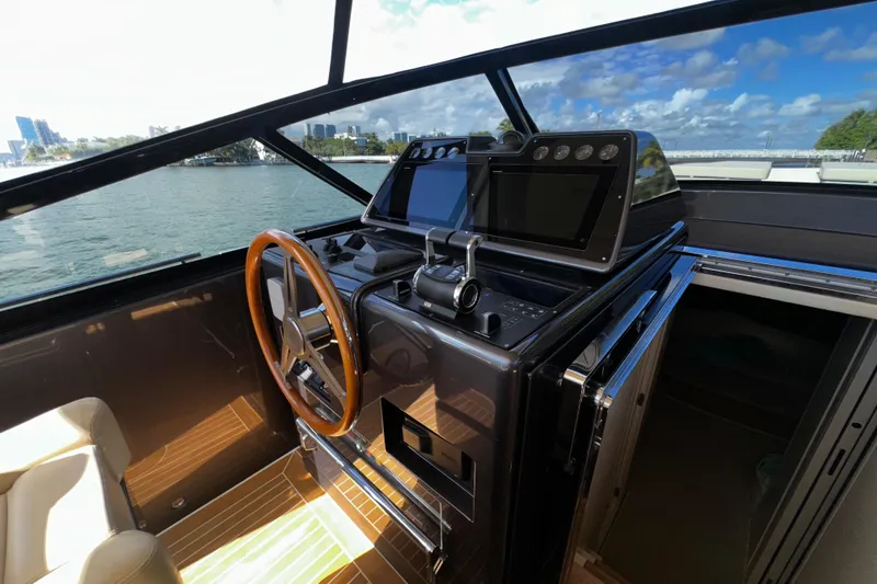 Slide: The Image of Luxurious CNM 54 yacht helm with wooden steering wheel and modern navigation controls, 2019 model. - 7