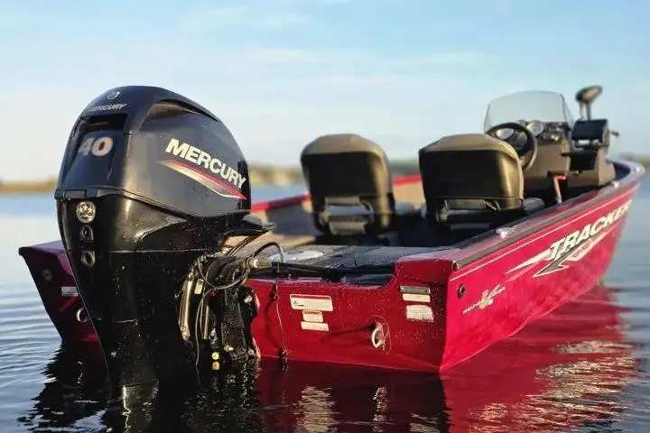 Slide: The Image of 2021 Tracker Super Guide V-16 SC boat with Mercury 40 engine on calm water. - 10