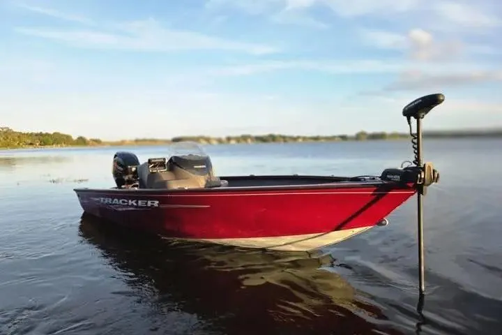 Slide: The Image of 2021 Tracker Super Guide V-16 SC boat on calm lake waters. - 13