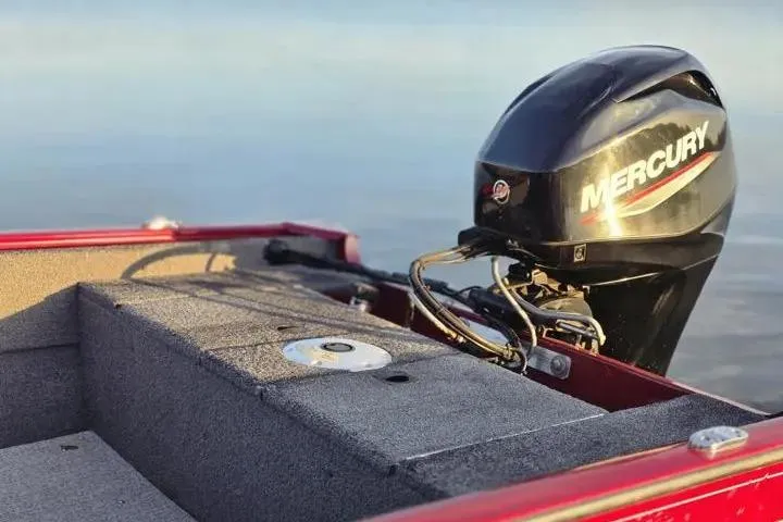 Slide: The Image of 2021 Tracker Super Guide V-16 SC boat with Mercury outboard motor on calm water. - 16