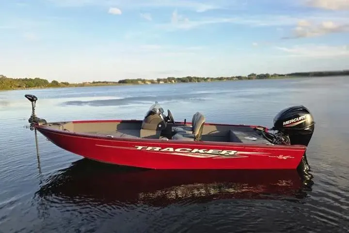 Slide: The Image of 2021 Tracker Super Guide V-16 SC boat on calm lake waters. - 6