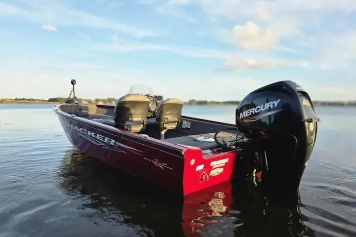 Slide: The Image of 2021 Tracker Super Guide V-16 SC boat with Mercury engine on calm water. - 7