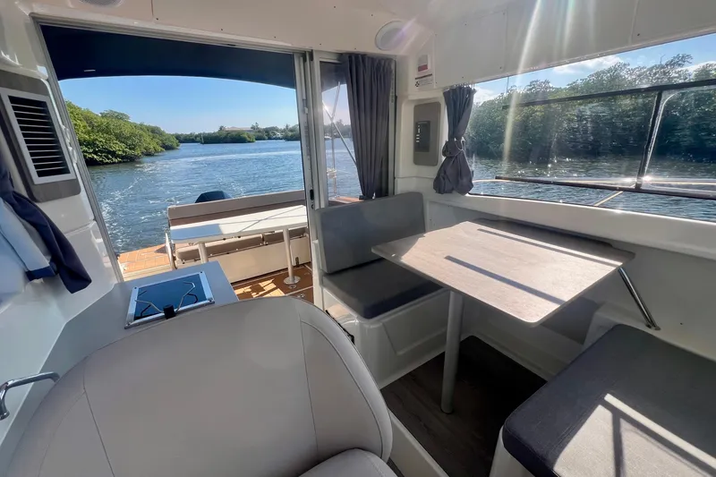 Slide: The Image of Interior of 2024 Bayliner Trophy T25 Explorer boat with seating and water view. - 10