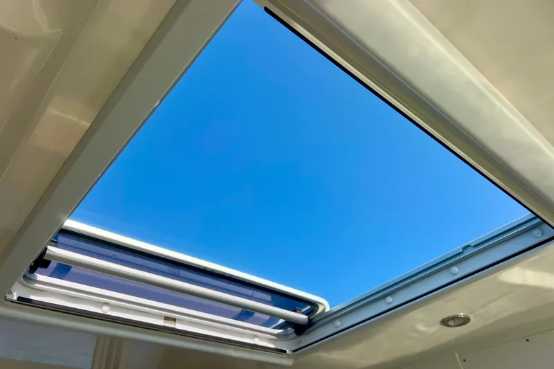 Slide: The Image of Open sunroof on 2024 Bayliner Trophy T25 Explorer, showcasing clear blue sky. - 23
