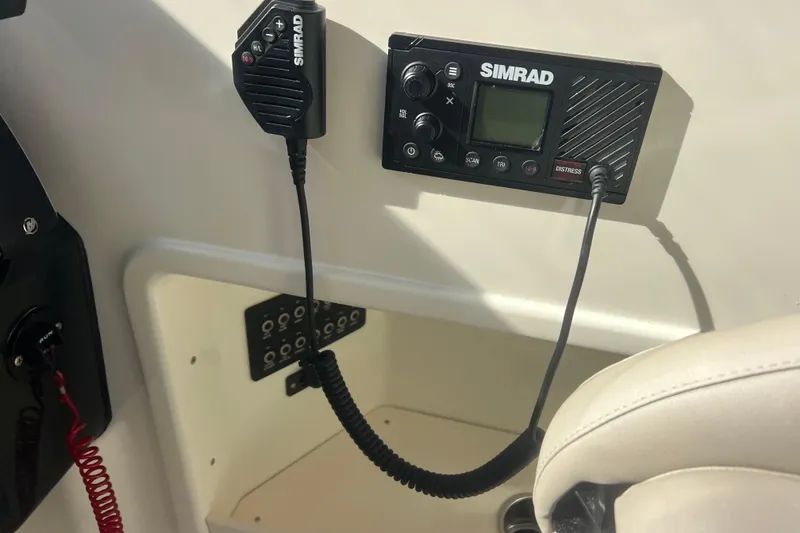 Slide: The Image of Simrad marine radio system on 2024 Bayliner Trophy T25 Explorer boat dashboard. - 6