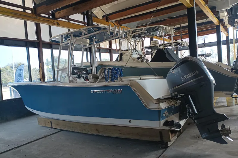 The Image of 2023 Sportsman Heritage 231 Center Console boat with Yamaha outboard in storage. - 0