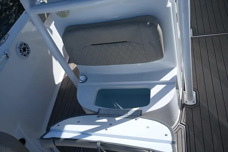 Slide: The Image of 2023 Sportsman Heritage 231 Center Console boat seat with storage compartment open. - 23