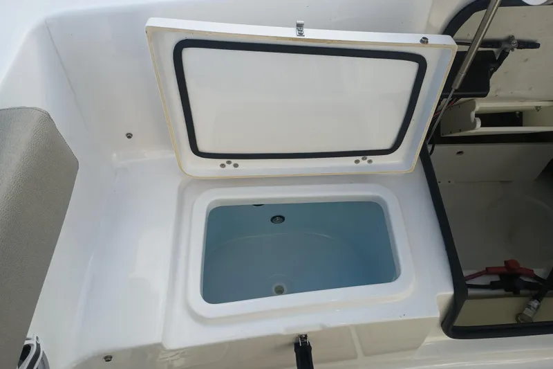 Slide: The Image of Open storage compartment on 2023 Sportsman Heritage 231 Center Console boat. - 26