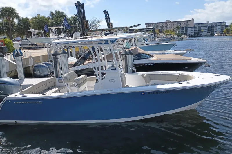 Slide: The Image of 2023 Sportsman Heritage 231 Center Console boat docked in marina, sunny day. - 32