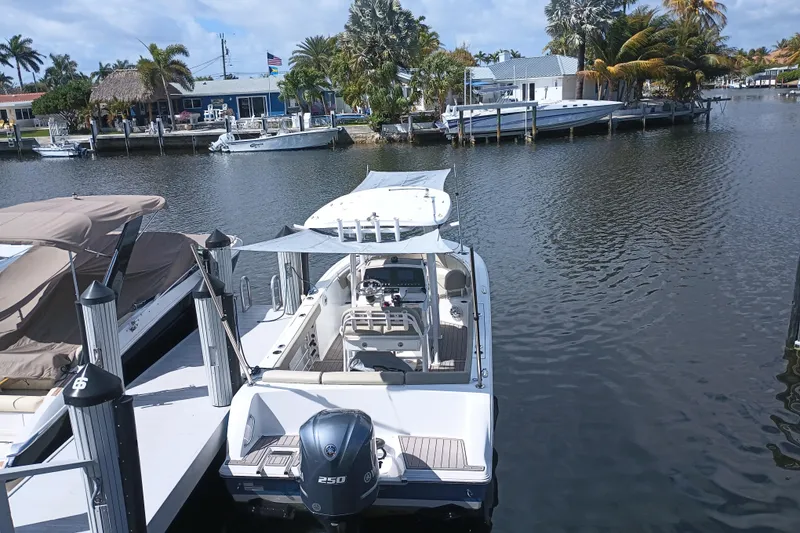 Slide: The Image of 2023 Sportsman Heritage 231 Center Console docked in a scenic marina setting. - 36
